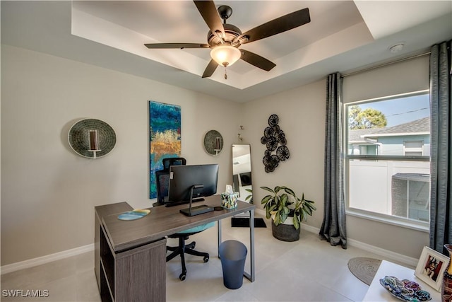 office with ceiling fan and a tray ceiling