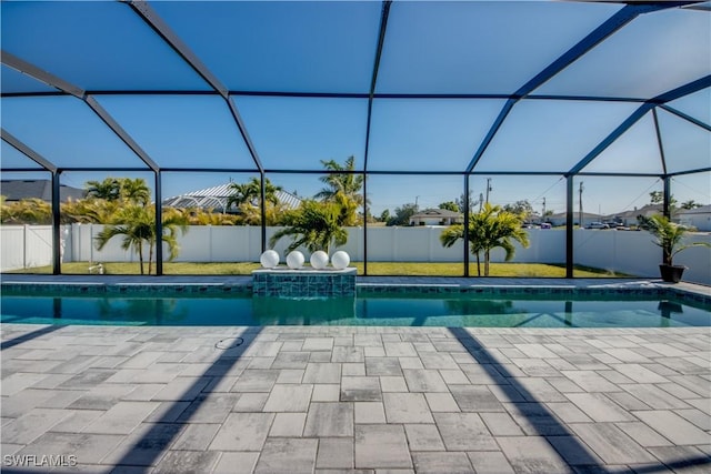 view of swimming pool with glass enclosure and a patio