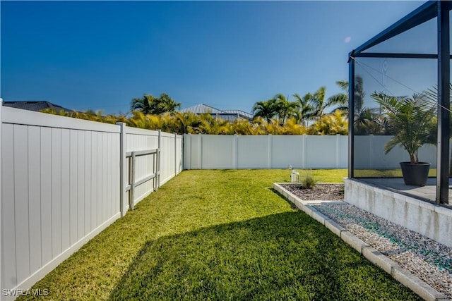 view of yard with glass enclosure