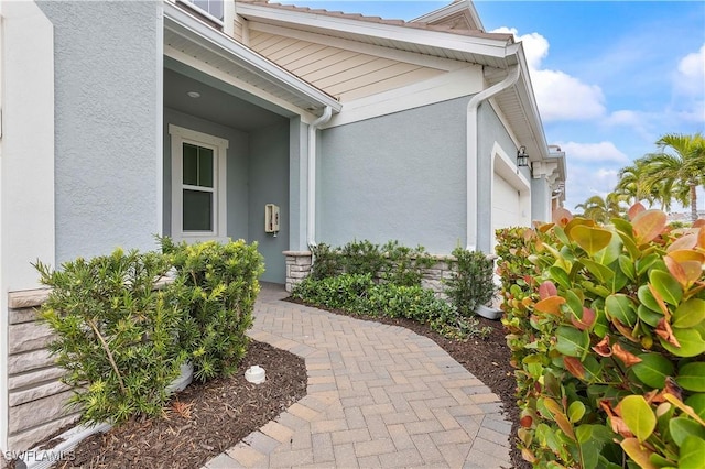 doorway to property with a garage