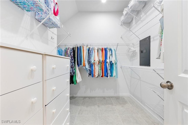 spacious closet with vaulted ceiling and tile patterned floors