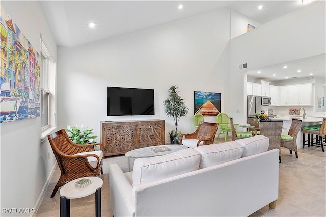 tiled living room featuring a high ceiling