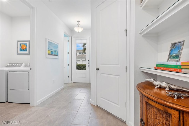 hallway featuring light tile patterned floors and independent washer and dryer