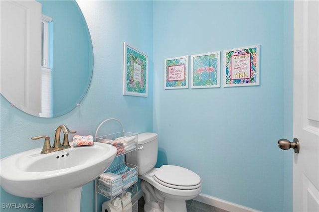 bathroom featuring toilet and sink