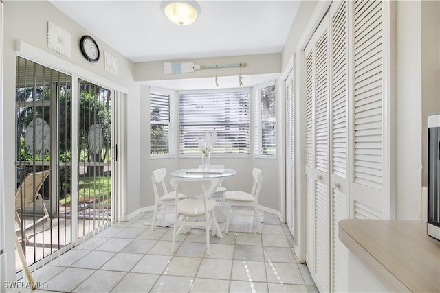 dining space featuring light tile patterned floors