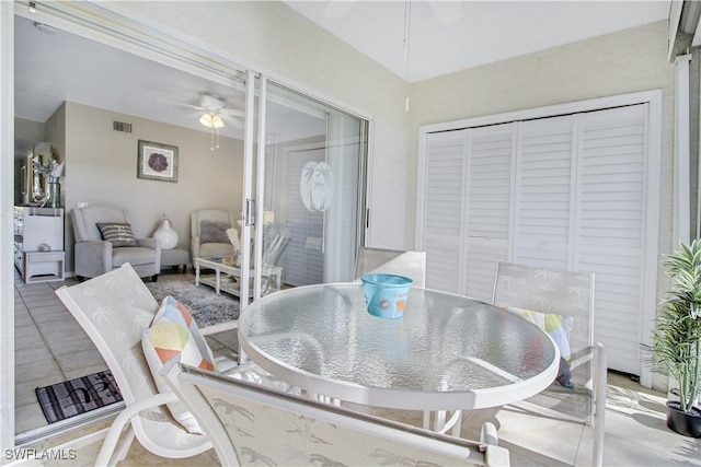 dining space featuring ceiling fan and tile patterned flooring