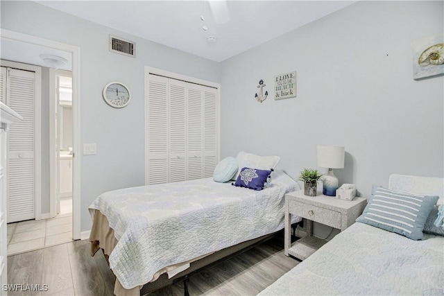 bedroom with hardwood / wood-style floors, a closet, and ceiling fan