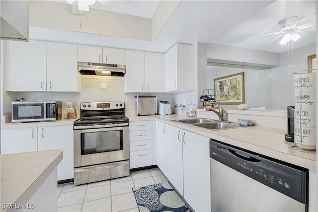 kitchen featuring light tile patterned flooring, appliances with stainless steel finishes, sink, white cabinets, and ceiling fan