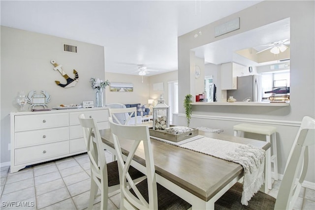 dining space featuring light tile patterned floors and ceiling fan