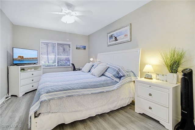 bedroom with light hardwood / wood-style floors and ceiling fan