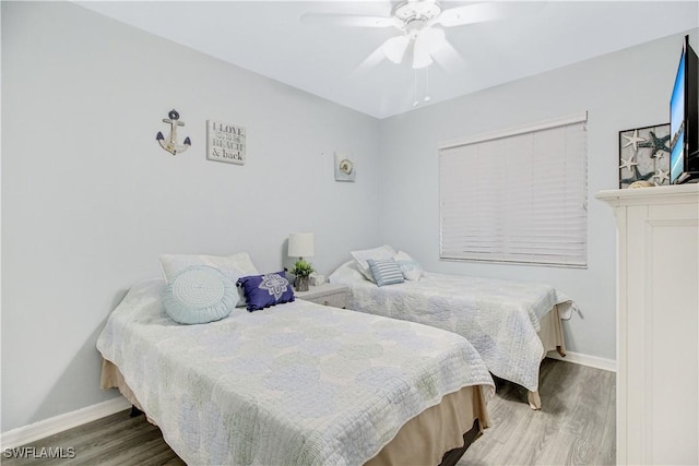 bedroom featuring ceiling fan and wood-type flooring