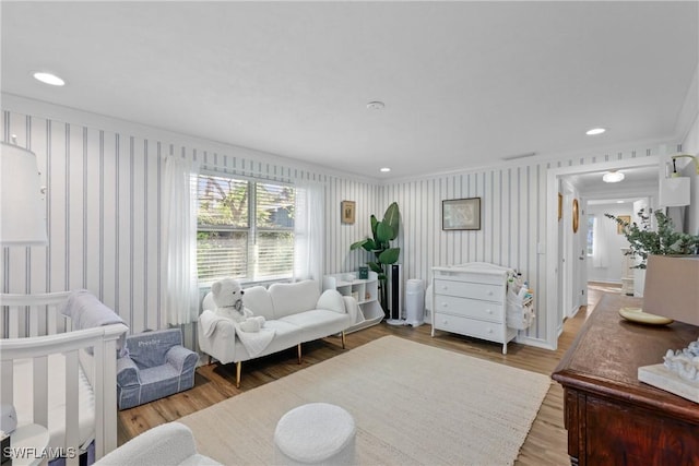 living room with ornamental molding and hardwood / wood-style floors