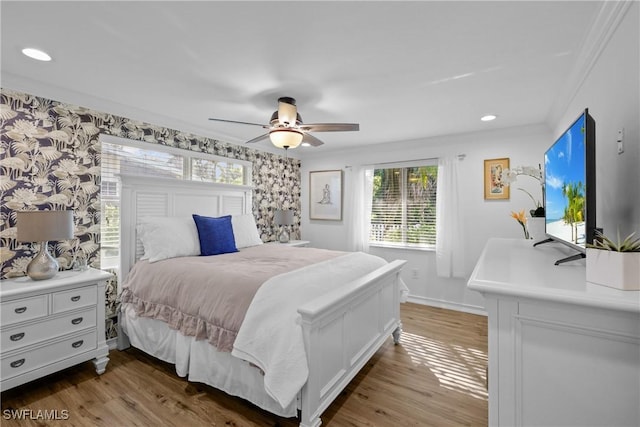 bedroom with ceiling fan, ornamental molding, and hardwood / wood-style flooring