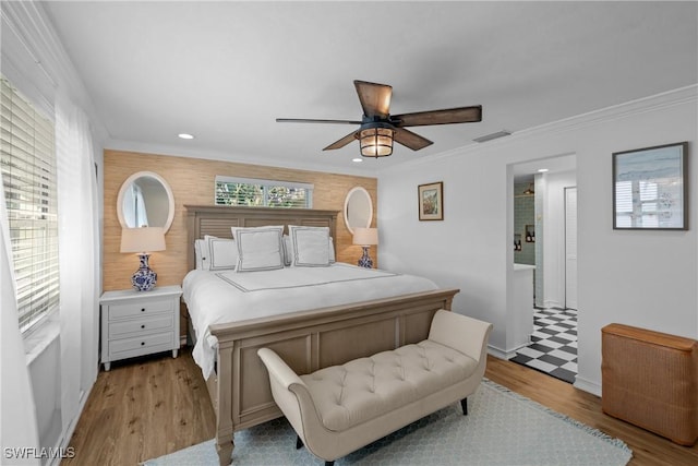 bedroom with ceiling fan, crown molding, and light hardwood / wood-style floors