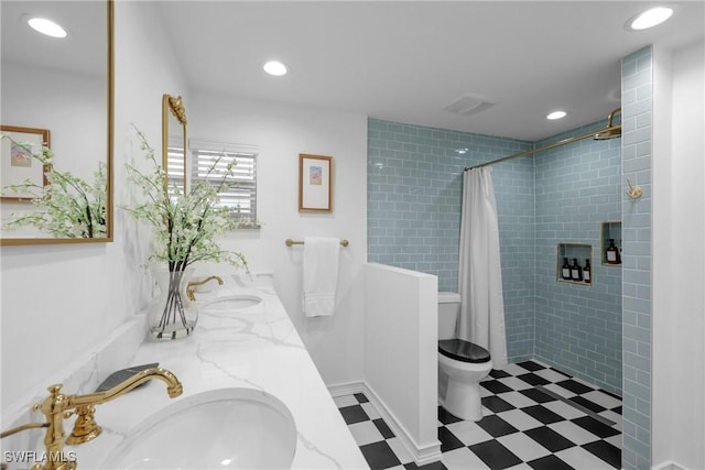 bathroom featuring toilet, vanity, and a shower with curtain