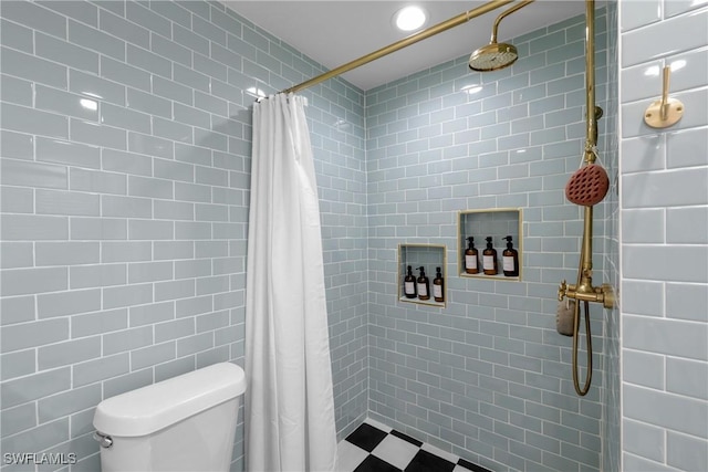 bathroom with tile walls and curtained shower