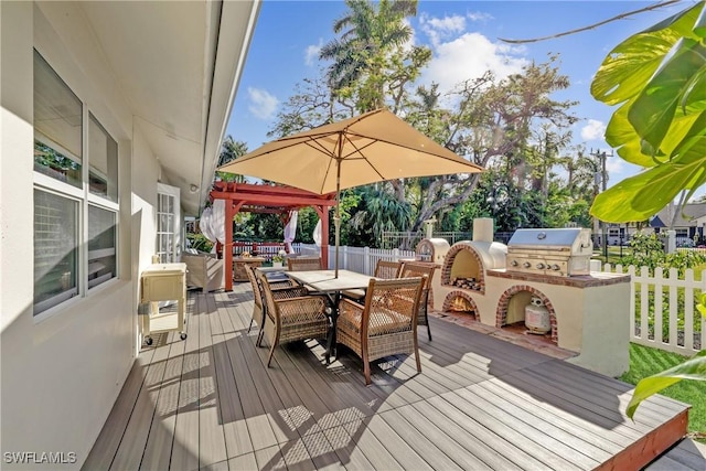 deck featuring exterior kitchen and grilling area