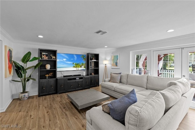 living room featuring crown molding and light hardwood / wood-style floors