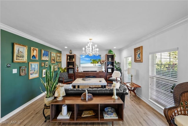 living room featuring crown molding, a chandelier, and light hardwood / wood-style flooring