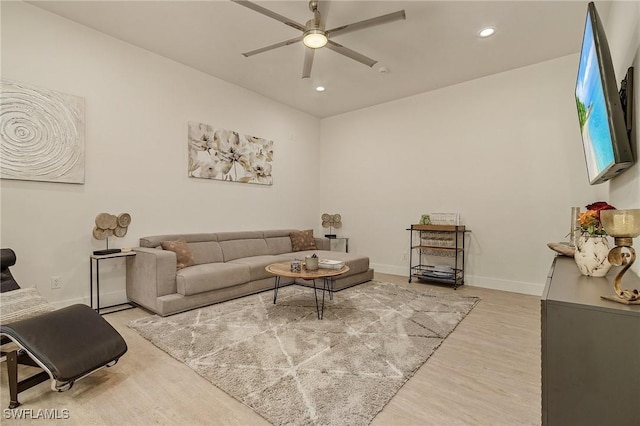 living room featuring light wood-type flooring and ceiling fan