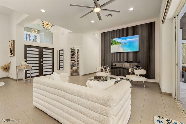 tiled living room featuring ceiling fan and plenty of natural light