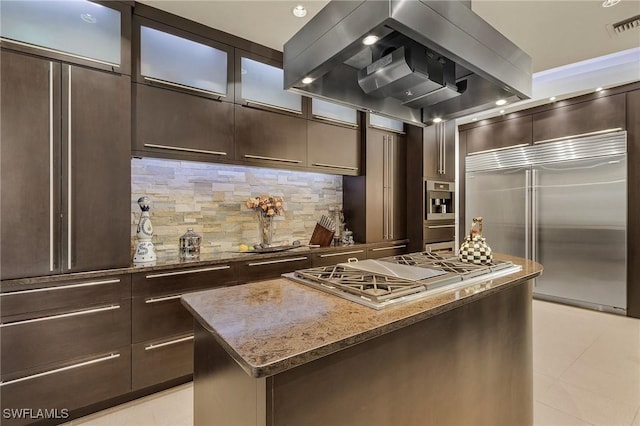 kitchen featuring backsplash, a center island, stone counters, island range hood, and stainless steel appliances