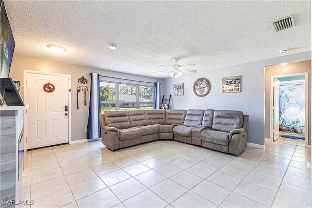 living room with light tile patterned flooring, a textured ceiling, and ceiling fan