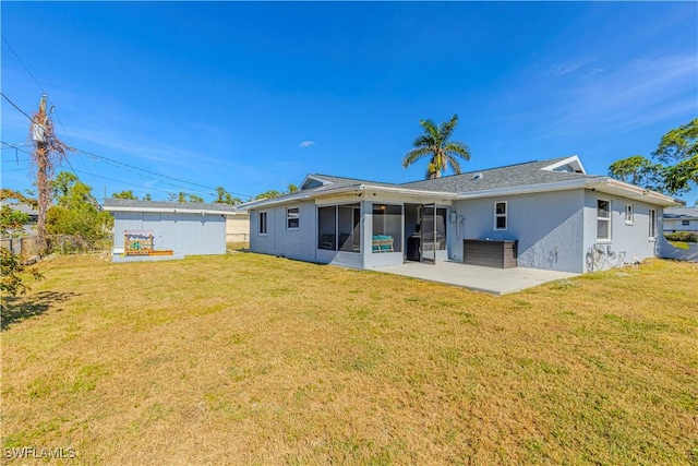 rear view of property with a patio area, a yard, and a sunroom