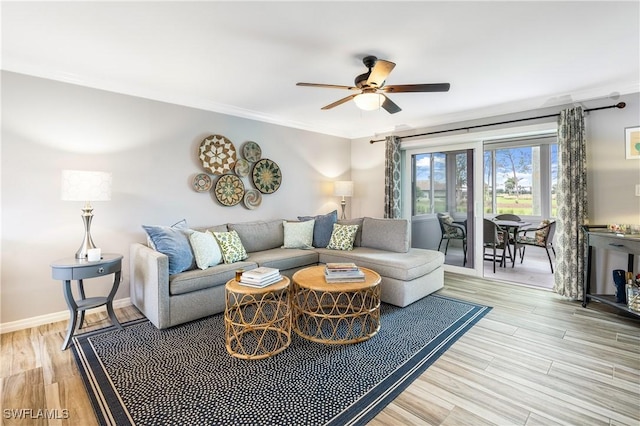 living room featuring light wood-type flooring, ceiling fan, and crown molding