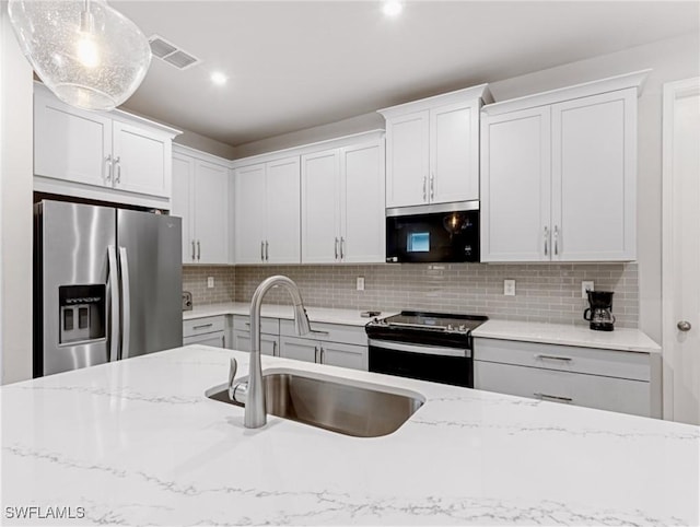 kitchen with white cabinetry, black range with electric cooktop, sink, hanging light fixtures, and stainless steel fridge with ice dispenser