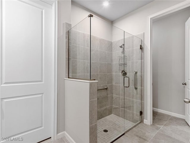 bathroom featuring tile patterned floors and an enclosed shower