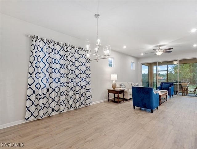 living room featuring ceiling fan and light hardwood / wood-style flooring