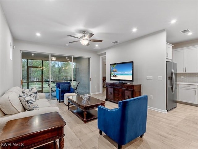 living room with light hardwood / wood-style floors and ceiling fan