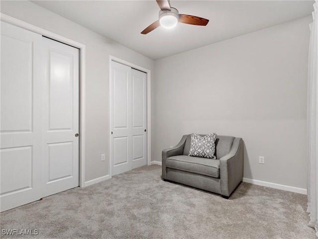 sitting room featuring ceiling fan and light colored carpet