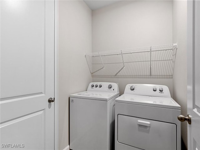 laundry room featuring washing machine and clothes dryer