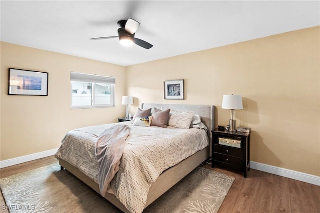 bedroom with ceiling fan and hardwood / wood-style floors