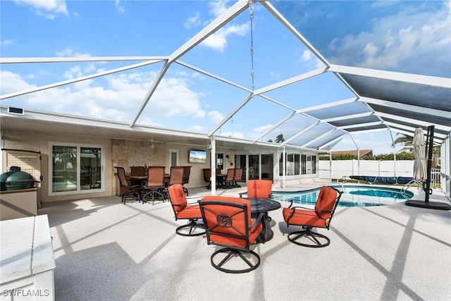 view of pool featuring glass enclosure and a patio