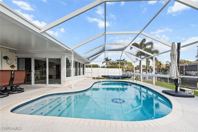 view of pool featuring a patio and glass enclosure