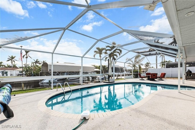 view of pool featuring a patio and glass enclosure