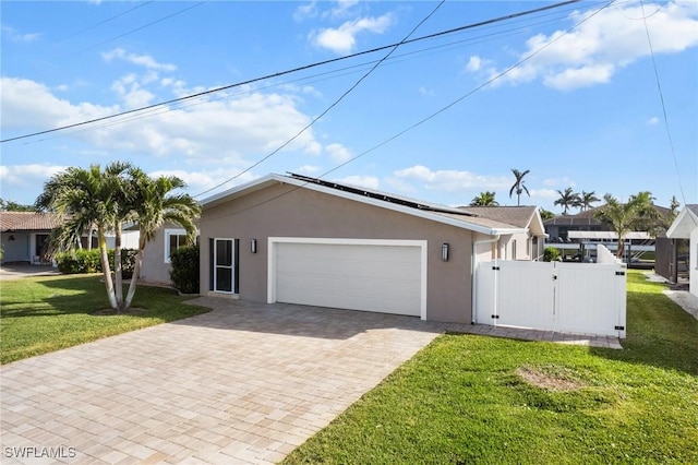 single story home featuring a garage and a front lawn