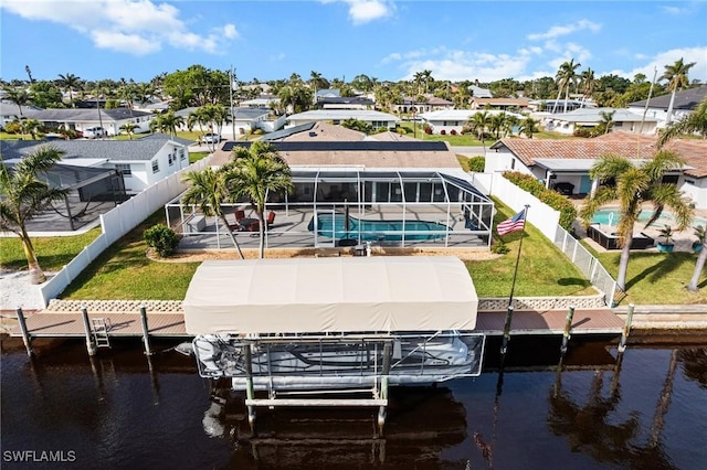 view of dock with a water view, a fenced in pool, a yard, and glass enclosure