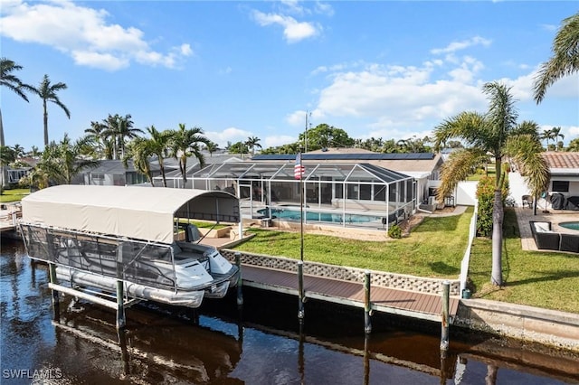 dock area featuring a lanai, a water view, and a yard