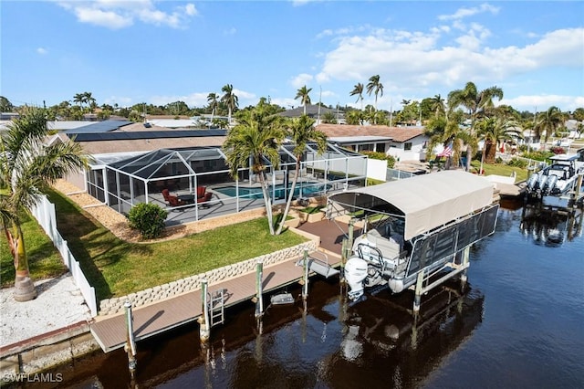 view of dock with glass enclosure, a yard, and a water view