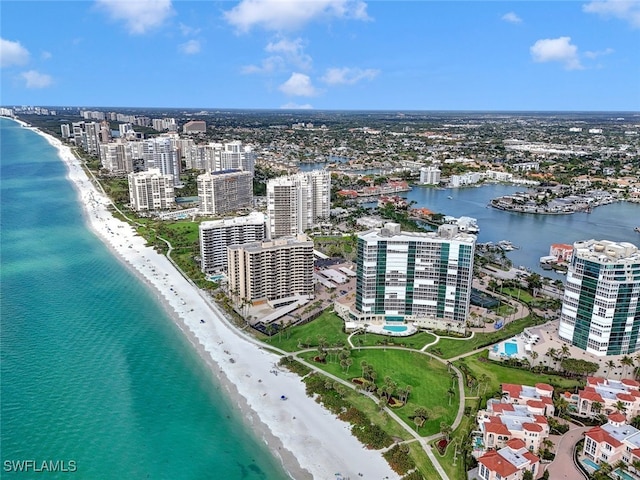 drone / aerial view featuring a beach view and a water view