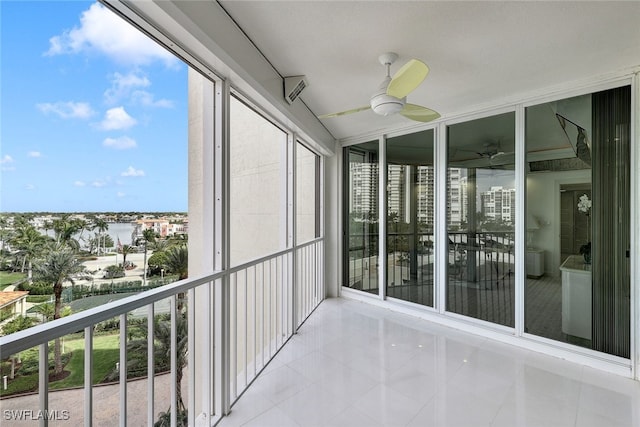 unfurnished sunroom with ceiling fan