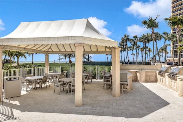 view of patio / terrace with an outdoor kitchen, a gazebo, sink, and a grill