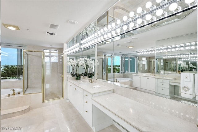 bathroom with tile patterned floors, independent shower and bath, and vanity