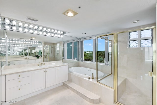 bathroom featuring vanity, tile patterned flooring, and separate shower and tub