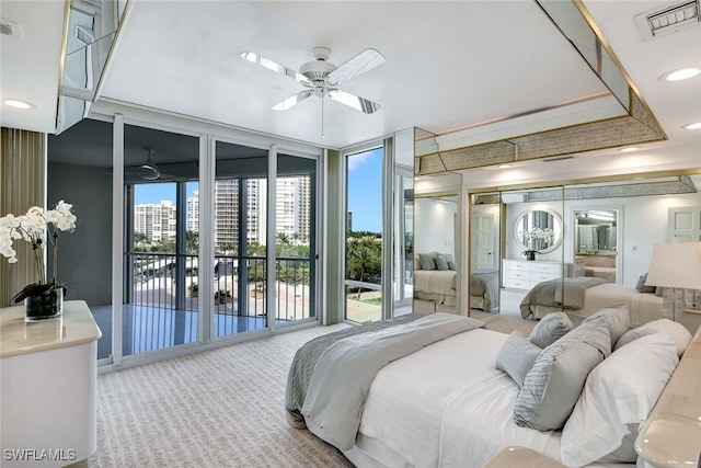 bedroom with floor to ceiling windows, ceiling fan, carpet flooring, and access to exterior