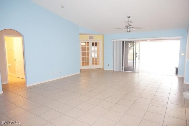 unfurnished room featuring french doors, ceiling fan, lofted ceiling, and light tile patterned floors